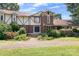 Inviting front exterior featuring a Tudor-style design with a brick facade and manicured landscaping at 24008 Carriker Rd, Albemarle, NC 28001