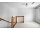 Hallway with carpet flooring, wood railing, and white walls at 24008 Carriker Rd, Albemarle, NC 28001