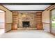 Bright living room showcasing a stone fireplace, built-in bookshelves, and a cozy atmosphere at 24008 Carriker Rd, Albemarle, NC 28001