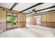 Bright living room with ceiling fan, exposed beams, and sliding glass doors to sun room at 24008 Carriker Rd, Albemarle, NC 28001