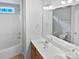 Bright bathroom featuring a double vanity, a large mirror, and a shower-tub combination at 2479 N Legacy Park Blvd, Fort Mill, SC 29707