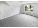 Bedroom with neutral carpet, white door, and a window with street views at 2479 N Legacy Park Blvd, Fort Mill, SC 29707