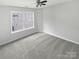 Bedroom with plush carpeting, ceiling fan, and a window with neighborhood views at 2479 N Legacy Park Blvd, Fort Mill, SC 29707