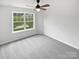 Bedroom with neutral carpet, ceiling fan, and a window with residential street views at 2479 N Legacy Park Blvd, Fort Mill, SC 29707