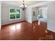 Open dining room with wood floors, wainscoting, view of front yard and adjacent room at 2479 N Legacy Park Blvd, Fort Mill, SC 29707