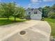 Beautiful home featuring a lush green lawn and a large driveway leading to a two-car garage at 2479 N Legacy Park Blvd, Fort Mill, SC 29707
