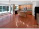 Open kitchen with wood cabinets, island, and a view of the sunroom and backyard at 2479 N Legacy Park Blvd, Fort Mill, SC 29707