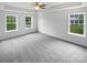Large main bedroom featuring plush carpeting, a ceiling fan, and ample natural light at 2479 N Legacy Park Blvd, Fort Mill, SC 29707