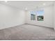 Bright bedroom with neutral carpet, white walls, and two windows that let in natural light at 270 Bezelle Ave, York, SC 29745