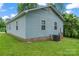 Exterior view of the home with light blue siding and green grass at 301 Honeywood Ave, Charlotte, NC 28216