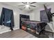 Bedroom with wood-look floors, a ceiling fan, and a black upholstered bed with black bedding at 301 Honeywood Ave, Charlotte, NC 28216