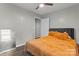 Neutral bedroom featuring ceiling fan, orange comforter set against gray walls and wood-look laminate floors at 301 Honeywood Ave, Charlotte, NC 28216