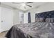 Bedroom with wood-look floors, a ceiling fan, and a black upholstered bed at 301 Honeywood Ave, Charlotte, NC 28216