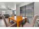 Dining room featuring a wooden table, cushioned chairs, and large window with blinds at 301 Honeywood Ave, Charlotte, NC 28216