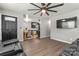 Open floor plan with laminate floors and gray walls connecting the living room to the dining area and kitchen at 301 Honeywood Ave, Charlotte, NC 28216