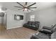 Open concept living room with laminate flooring, a modern ceiling fan, and reclining leather couches at 301 Honeywood Ave, Charlotte, NC 28216