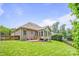 Well-maintained backyard with green grass and trees, showcasing the home's exterior and serene outdoor space at 305 River Birch Cir, Mooresville, NC 28115