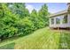 Expansive backyard featuring lush lawn and mature trees offering privacy and a serene outdoor space at 305 River Birch Cir, Mooresville, NC 28115