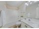 Bathroom with a tub-shower combo, white vanity, and bright lighting at 305 River Birch Cir, Mooresville, NC 28115