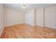 Bright bedroom with hardwood floors, neutral walls, ceiling fan, and closet space at 305 River Birch Cir, Mooresville, NC 28115