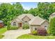 Charming brick home with manicured landscaping and a well-maintained front yard at 305 River Birch Cir, Mooresville, NC 28115