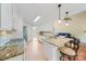 Bright kitchen featuring granite countertops, stainless steel appliances, and open floor plan at 305 River Birch Cir, Mooresville, NC 28115