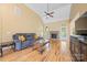 Comfortable living room featuring a fireplace, hardwood floors, high ceilings, and natural light at 305 River Birch Cir, Mooresville, NC 28115