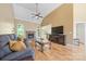 Cozy living room features a fireplace, hardwood floors, high ceiling, and large windows at 305 River Birch Cir, Mooresville, NC 28115