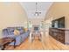 Inviting living room with high ceilings, hardwood floors, fireplace, and ample natural light at 305 River Birch Cir, Mooresville, NC 28115
