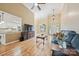 Open-concept living room connected to kitchen with hardwood floors, large window, and comfortable seating at 305 River Birch Cir, Mooresville, NC 28115