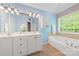 Main bathroom with double vanity, soaking tub, and serene natural light at 305 River Birch Cir, Mooresville, NC 28115