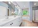 Main bathroom with double vanity, soaking tub, and natural light at 305 River Birch Cir, Mooresville, NC 28115
