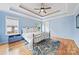 Tranquil main bedroom with tray ceilings, hardwood floors, and natural light at 305 River Birch Cir, Mooresville, NC 28115