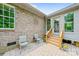 Charming patio with brick paving and chairs, leading to the backyard, perfect for relaxing outdoors at 305 River Birch Cir, Mooresville, NC 28115