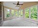 Bright sunroom with multiple windows, carpeted flooring, and a ceiling fan, perfect for relaxing at 305 River Birch Cir, Mooresville, NC 28115