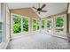 Light filled sunroom with large windows offering a view of backyard greenery at 305 River Birch Cir, Mooresville, NC 28115
