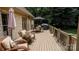 Relaxing deck area featuring comfortable seating, a dining table, and a grill, perfect for outdoor entertaining at 3273 16Th Ne St, Hickory, NC 28601