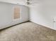 A bright carpeted bedroom with a window and a ceiling fan at 3436 Ibis Ln, Fort Mill, SC 29707