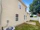 Side view of a light-colored home with a fenced backyard and green grass at 3436 Ibis Ln, Fort Mill, SC 29707