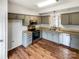 Updated kitchen with stainless steel appliances, gray cabinets, and wood floors at 3436 Ibis Ln, Fort Mill, SC 29707