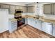 Modern kitchen featuring stainless steel appliances, stylish cabinets, and hardwood floors at 3436 Ibis Ln, Fort Mill, SC 29707