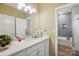 A bathroom featuring a double sink, a mirror, and neutral walls with tile flooring at 5357 Pembrey Dr, Denver, NC 28037