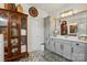A bathroom featuring unique tile flooring, neutral walls, a mirror, and under-sink storage space at 5357 Pembrey Dr, Denver, NC 28037