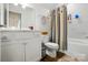 Bright bathroom with white tiled walls, sleek fixtures, and modern vanity at 5357 Pembrey Dr, Denver, NC 28037