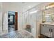 A bathroom featuring a stand up shower, a sliding wooden door, neutral walls, and tile flooring at 5357 Pembrey Dr, Denver, NC 28037