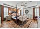 A bedroom featuring a dark wooden four-poster bed, wooden floors, and neutral walls with decorative accents at 5357 Pembrey Dr, Denver, NC 28037
