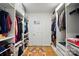 A walk-in closet with white shelving, wooden floors, and ample storage space at 5357 Pembrey Dr, Denver, NC 28037