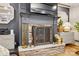 Elegant fireplace with stone surround, decorative accessories, and a mounted television at 5357 Pembrey Dr, Denver, NC 28037