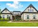 Charming home featuring a manicured lawn, stone accents, and symmetrical architectural details at 5357 Pembrey Dr, Denver, NC 28037