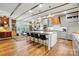 Open kitchen boasts a large island with seating, wood beams, and modern light fixtures at 5357 Pembrey Dr, Denver, NC 28037